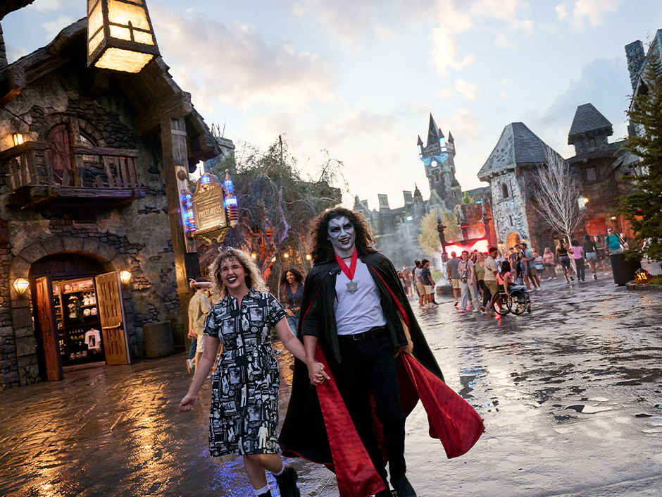 Two guests in monster makeup walking around Dark Universe
