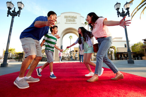 Family on red carpet outside of Universal Studios Hollywood arch.