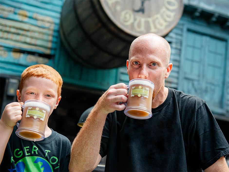 A father and son sipping Butterbeer in Diagon Alley in Universal Studios Florida