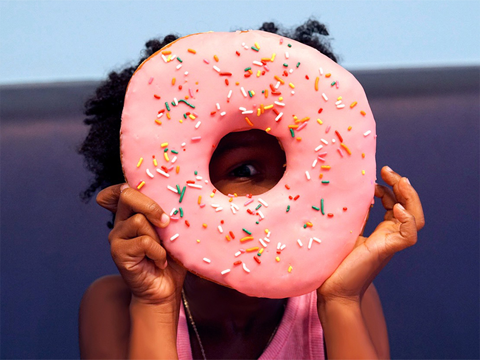 A guest holds the Big Pink donut from Lard Lad Donuts at Universal Studios Hollywood.