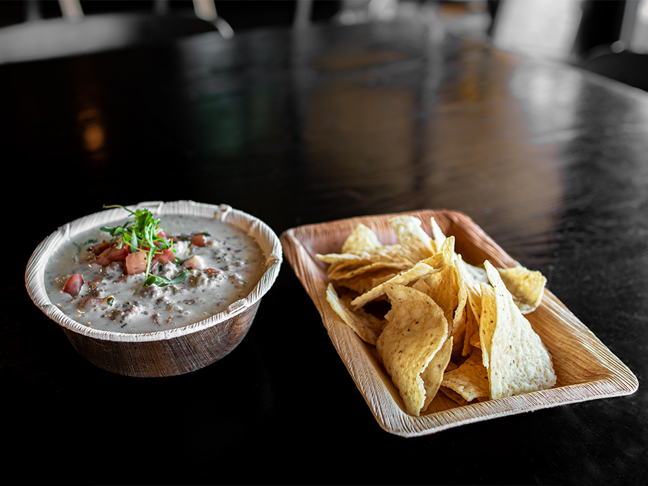 Bowl of Beef Queso Dip and Tortilla Chips at NBC Sports Grill & Brew for the Super Bowl.