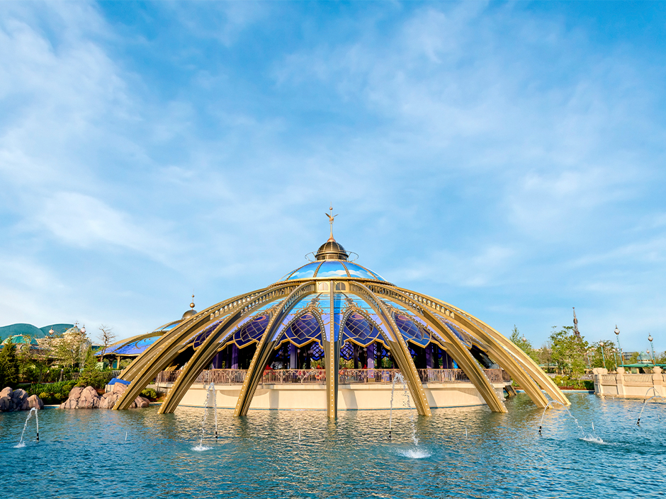 A view of Constellation Carousel across the lagoon in Celestial Park at Epic Universe