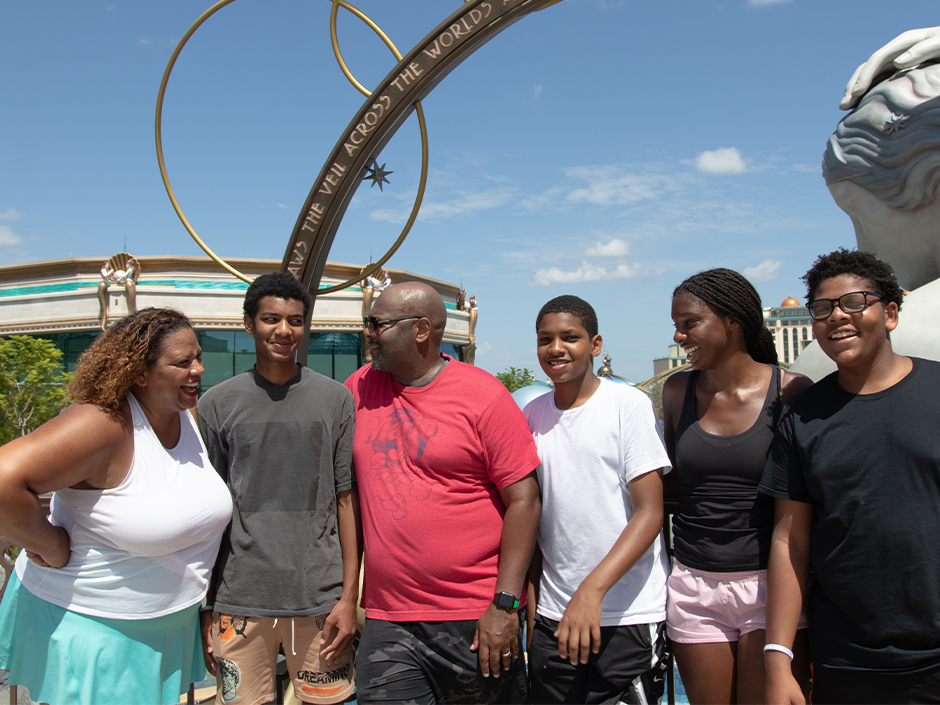Maria Smith posing with her husband and children at Universal Epic Universe.