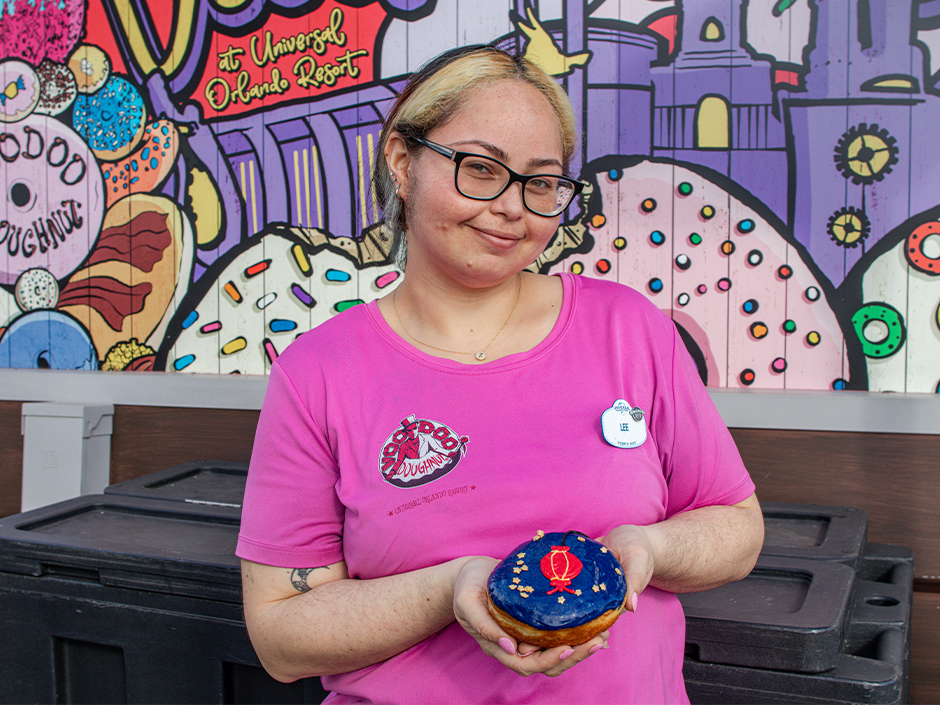 Chef Assistant Lee Santiago Bermudez holding The Horse Lantern doughnut she made for Lunar New Year.