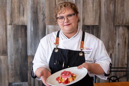 VIVO Sous Chef Isabel Thompson holding her Strawberry & Rhubarb Panna Cotta for Women's Herstory Month.