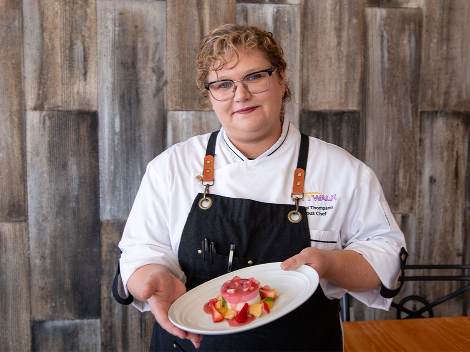 VIVO Sous Chef Isabel Thompson holding her Strawberry & Rhubarb Panna Cotta for Women's Herstory Month.
