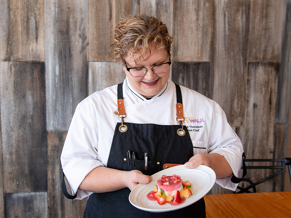 VIVO sous chef Isabel Thompson holding her Strawberry & Rhubarb Panna Cotta for Women's Herstory Month.