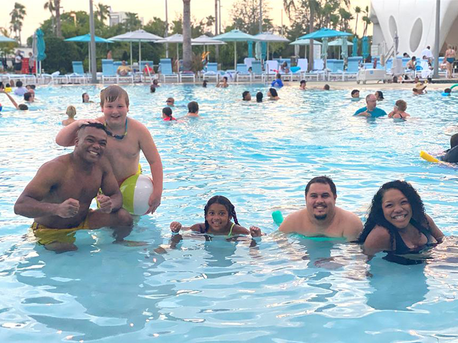 Danielle and her family pose for a photo in the pool at Universal Terra Luna Resort