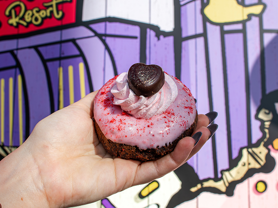 Hand holding the Love Twist doughnut for Valentine's Day at Voodoo Doughnut in Universal CityWalk.