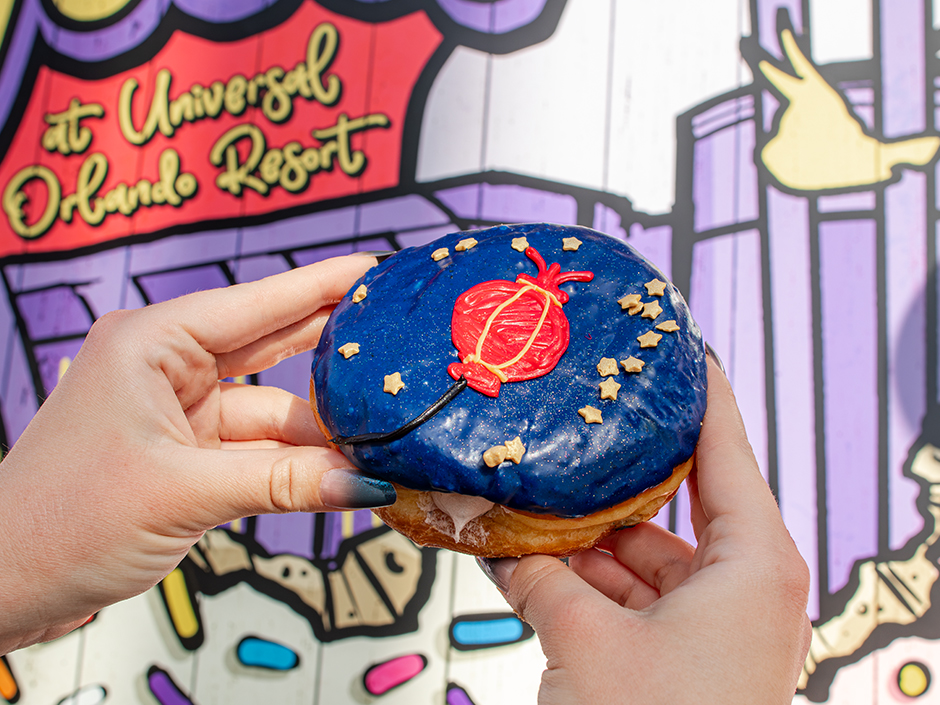 Hands holding The Horse Lantern doughnut at Voodoo Doughnut for Lunar New Year.