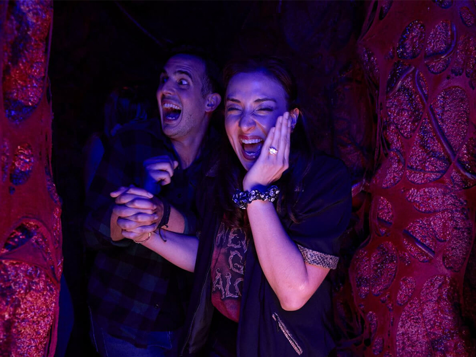 Friends laugh and scream at Halloween Horror Nights.