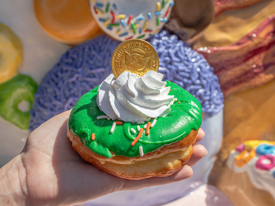 Hand holding the Lepre-Creme Loot doughnut at Voodoo Doughnut for St. Patrick's Day.