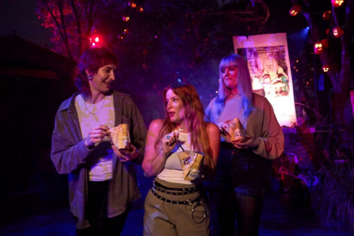 Friends enjoy walking tacos in a scare zone at Halloween Horror Nights