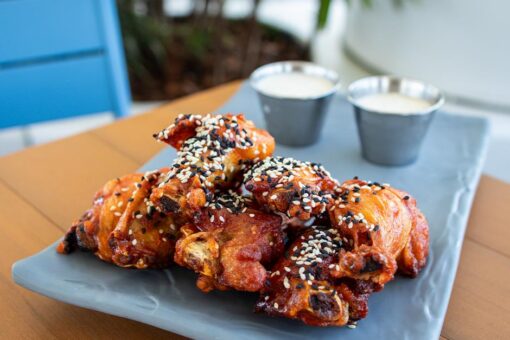 A photo of chicken wings on a plate at Universal Aventura Hotel.