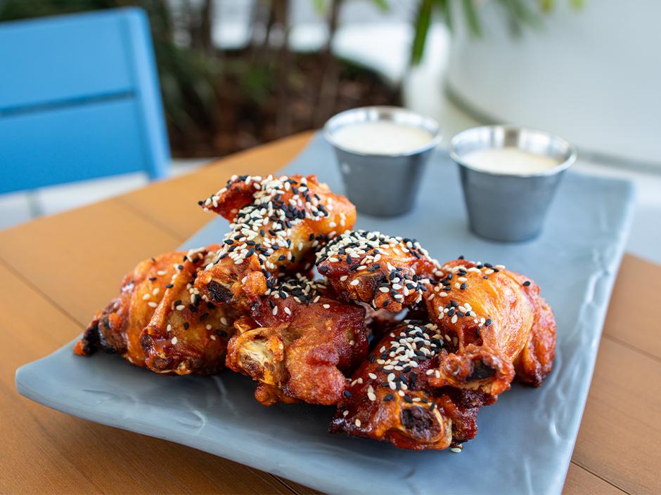 A photo of chicken wings on a plate at Universal Aventura Hotel.