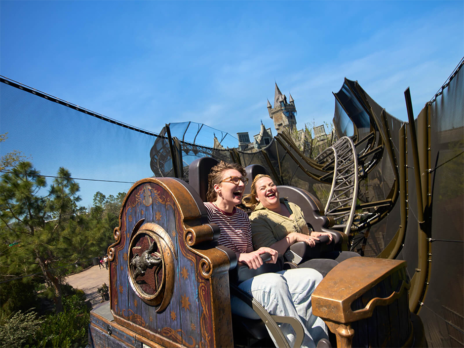 Two people laughing and riding Curse of the Werewolf at Universal Epic Universe.
