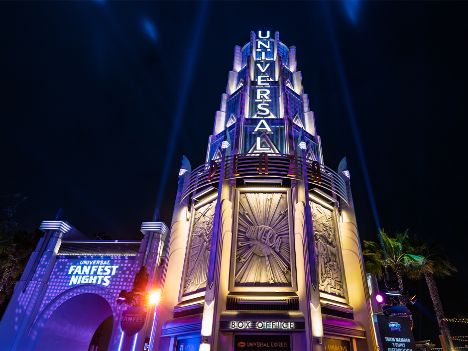Universal Tower lit up in blue and purple for Universal Fan Fest Nights.