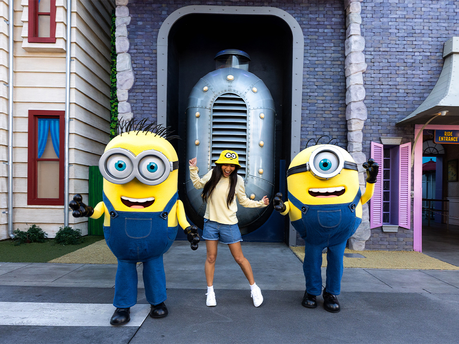 A guest danced in Minion apparel dances with two Minions in front of Despicable Me Minion Mayhem in Universal Studios Florida