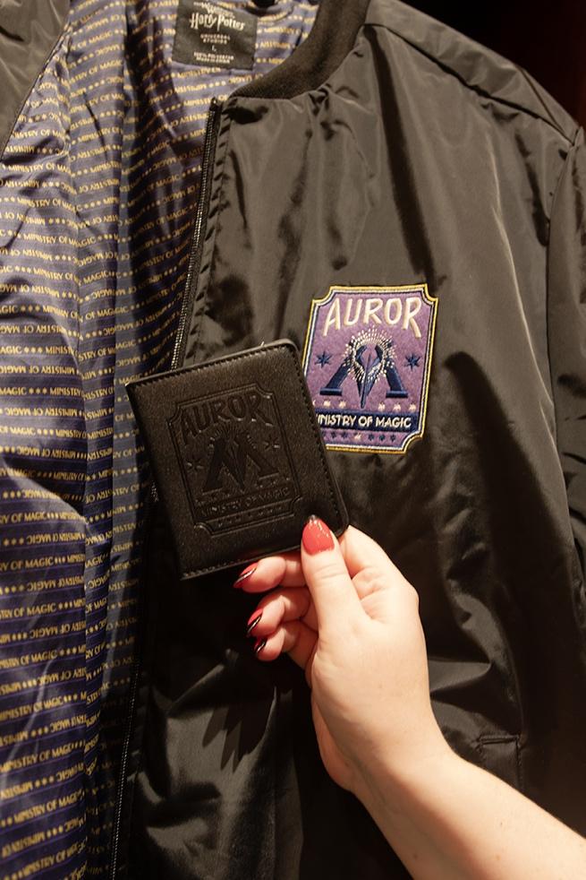 A photo of a jacket and other memorabilia with Auror emblems.