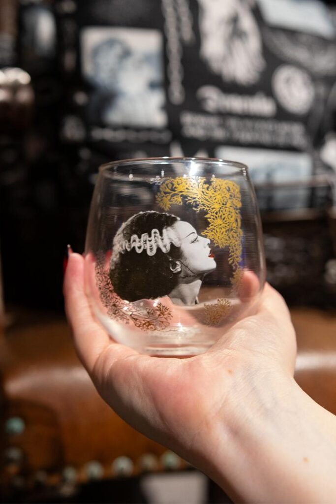 A glass with a Bride of Frankenstein emblem. 