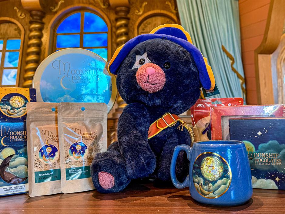 A photo of Moonship Chocolates, a mug, and a plush Captain Cacao.