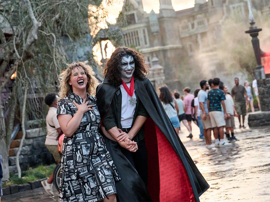Two guests in monster makeup walking around Dark Universe