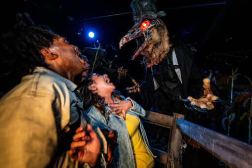 Guests get scared by a terrifying creature at Halloween Horror Nights.