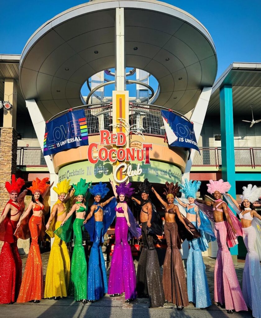 Stilt walkers dressed in the colors of the rainbow pose outside of Red Coconut Club at Universal CityWalk
