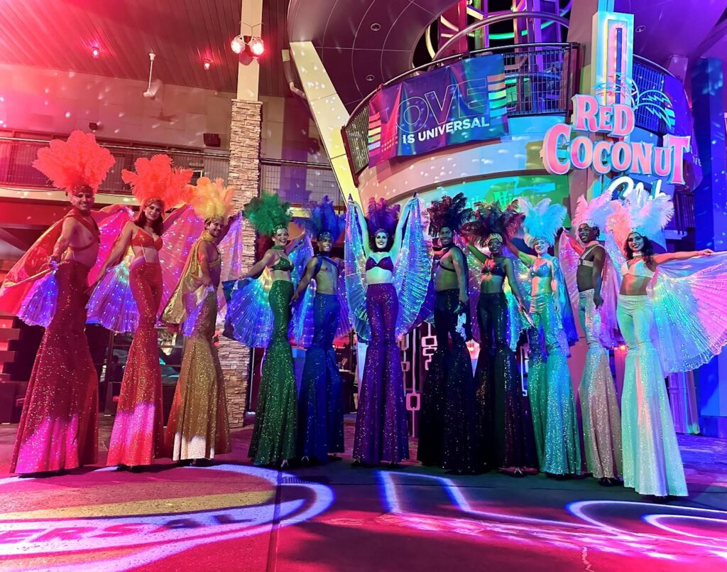 Stilt walkers dressed in the colors of the rainbow pose outside of Red Coconut Club at Universal CityWalk