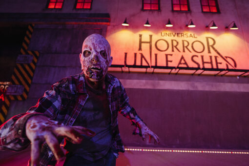 Zombie in front of Universal Horror Unleashed sign in Las Vegas