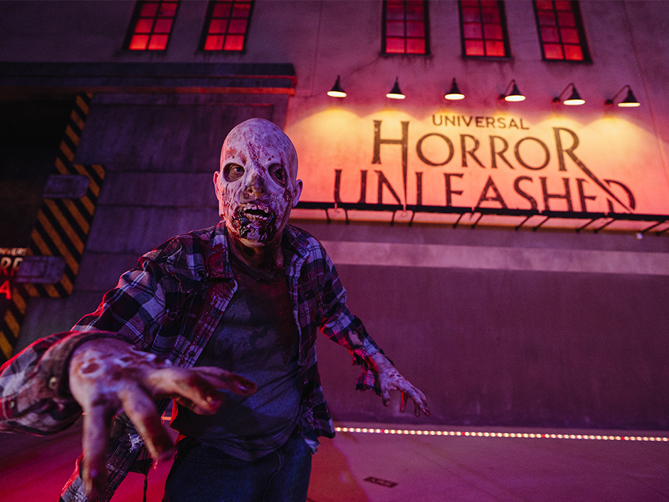 Zombie in front of Universal Horror Unleashed sign in Las Vegas