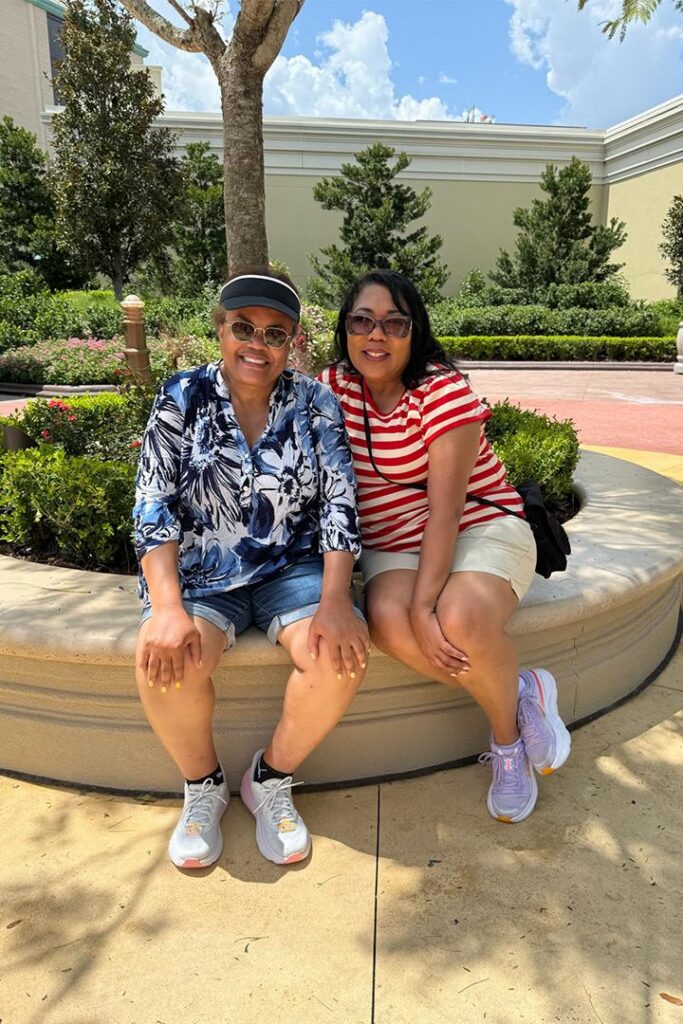 Danielle's parents pose for a photo in Epic Universe.