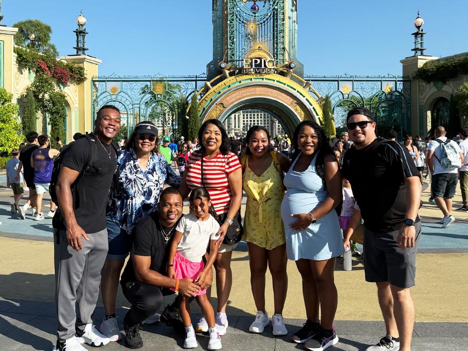 A photo of the whole family outside of the gates to Universal Epic Universe