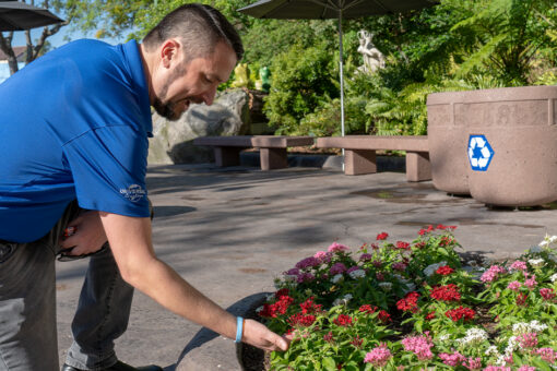Neil tending to a flower bed.