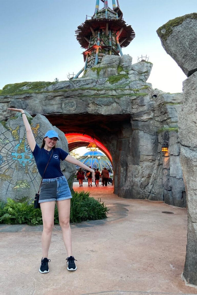 Kaitlyn poses in front of the portal to How to Train Your Dragon - Isle of Berk