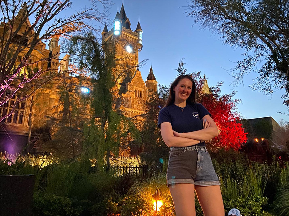 Kaitlyn poses in front of Monsters Unchained in Dark Universe