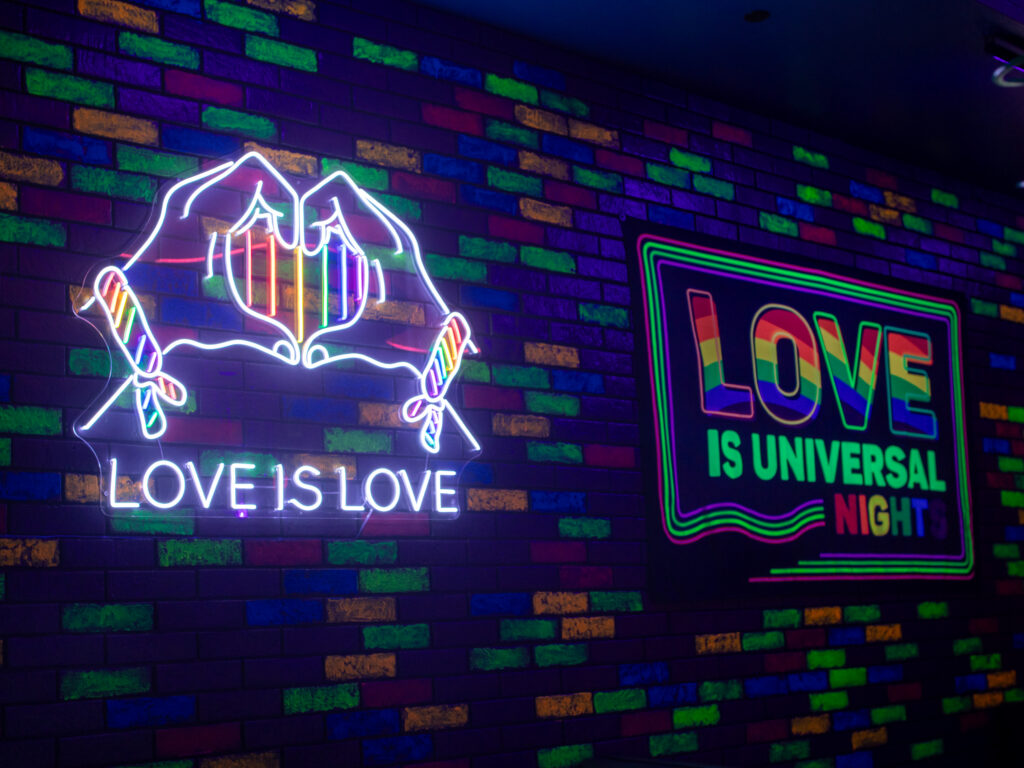 A photo of the neon signs at Love is Universal Nights at Red Coconut Club.