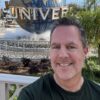 Headshot of Joe Irwin in front of the Universal globe
