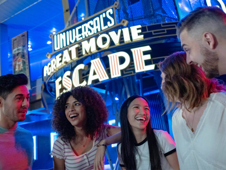 Four friends laugh outside of Great Movie Escape.