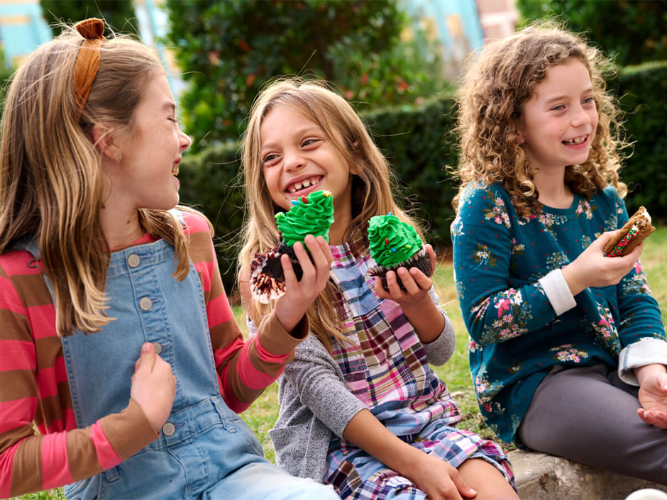 Three children enjoy holiday treats during the Holidays at Universal.