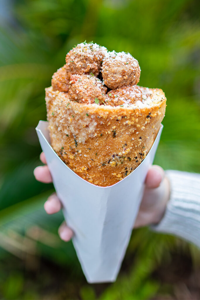 Hand holding a Meatball Marinara Bread Cone in Jurassic Park at Universal Islands of Adventure.