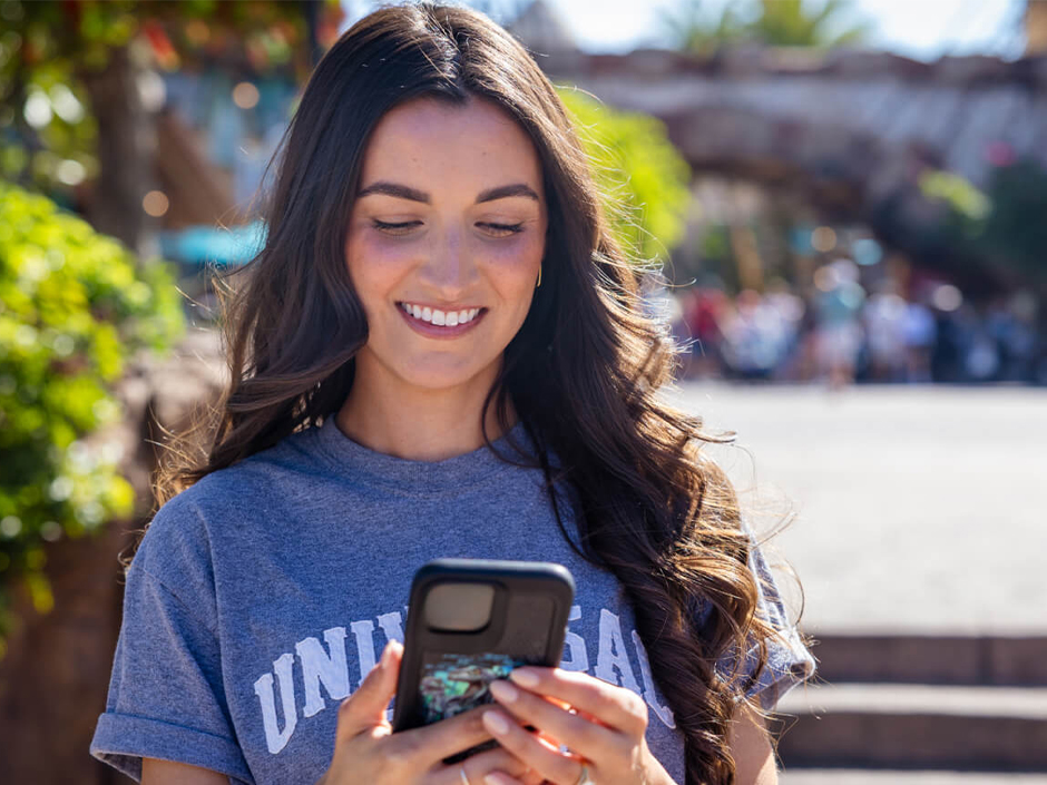 A woman uses her Universal Orlando Resort App.