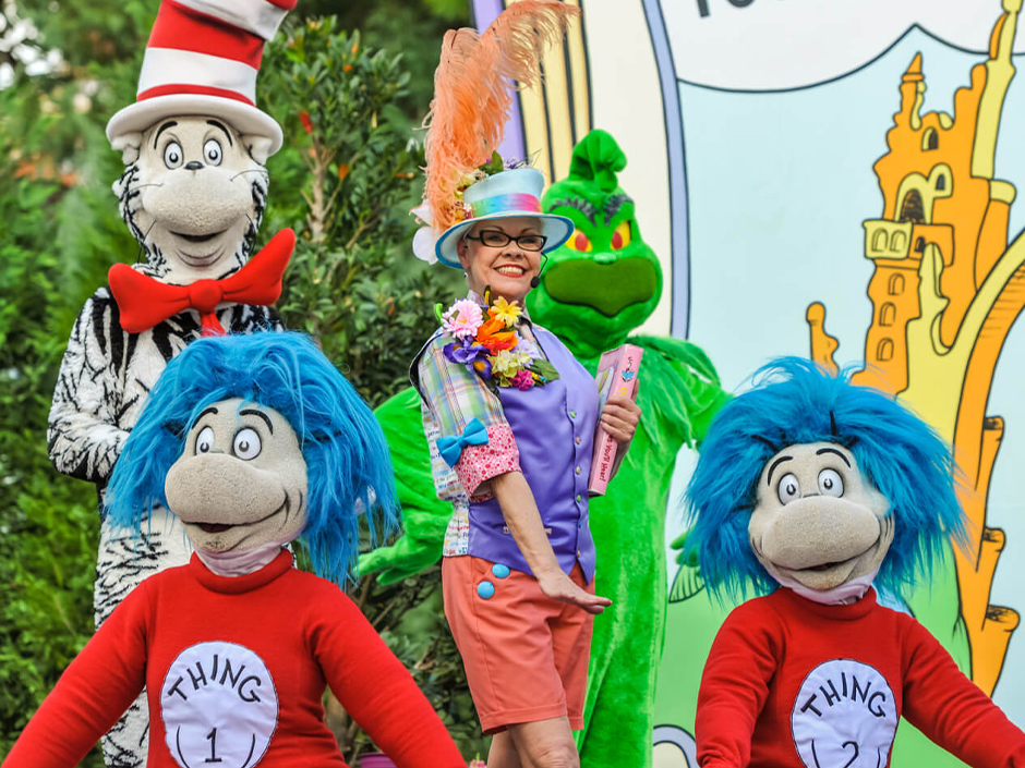 Thing 1, Thing 2, The Grinch, and The Cat in the Hat pose with a performer as part of Oh, the Stories You'll Hear!