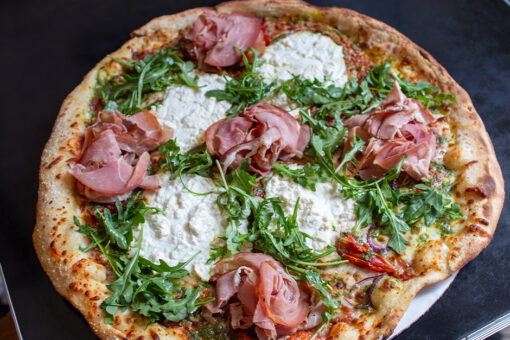 A whole prosciutto and arugula pizza for Passholder Appreciation Days.