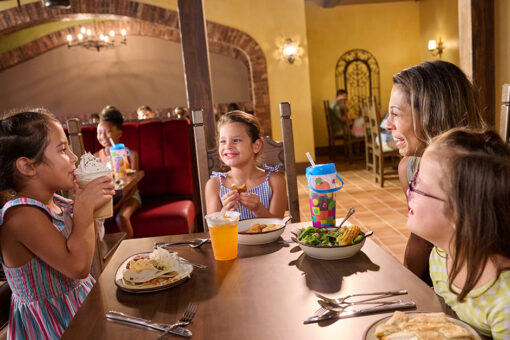 A group of children and an adult eating together at Universal Kids Resort