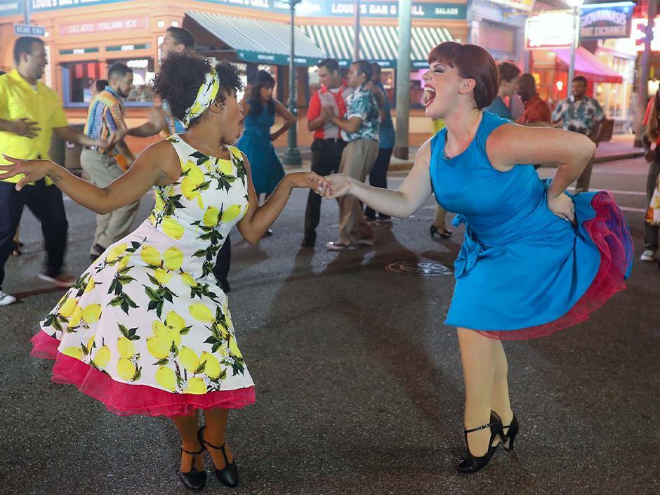 Two performers smile and dance together during Vamos - Bailalo at Universal Studios Florida