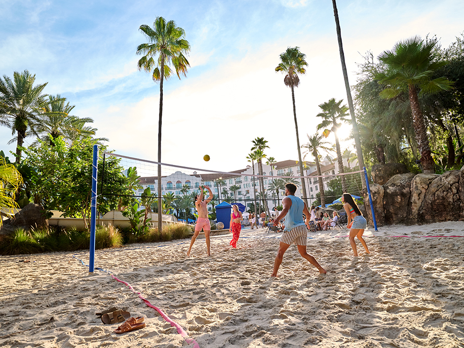 Friends play volleyball at a Universal Orlando hotel.