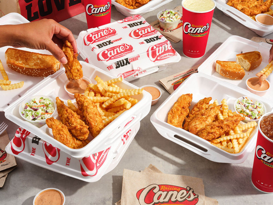 A table filled with Raising Cane's take out