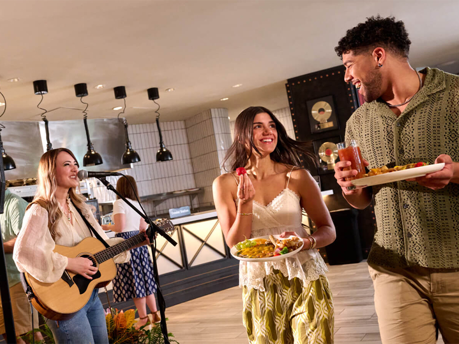 A couple smiles at each other while walking through The Kitchen at the Acoustic Brunch at Hard Rock Hotel