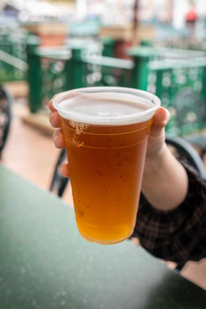 Hand holding a cup of Dufftoberfest Beer at Duff Gardens in Springfield U.S.A. at Universal Studios Florida.